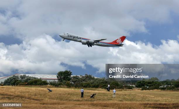 Boeing 747 Jumbo Jet Cargolux plane takes off from the Prestwick Airport as golfers watch on the seventh hole at Prestwick Golf Club on August 06,...