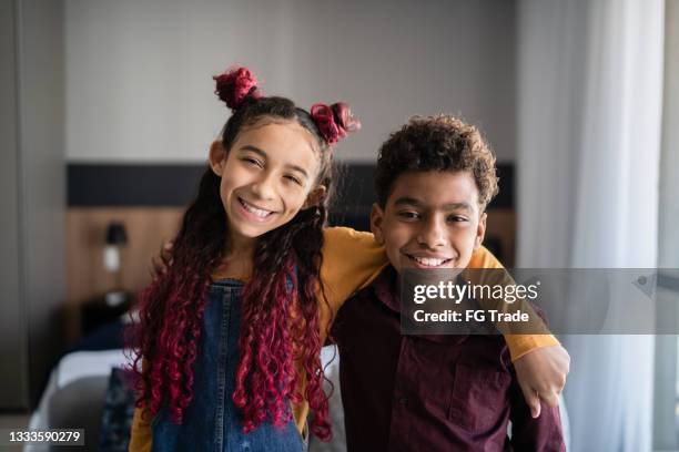 portrait of happy siblings at home - i love you brother stock pictures, royalty-free photos & images