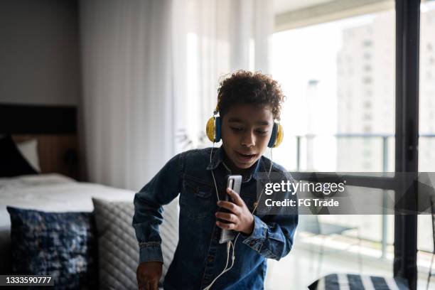happy boy singing and dancing at home - music enjoyment stock pictures, royalty-free photos & images