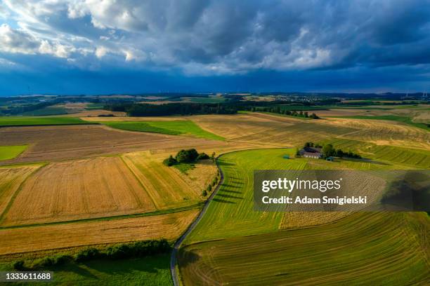 country road in the rural landscape (aerial) - wispy stock pictures, royalty-free photos & images