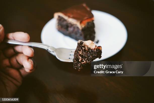 woman enjoys chocolate cake - chocolate cake stock pictures, royalty-free photos & images