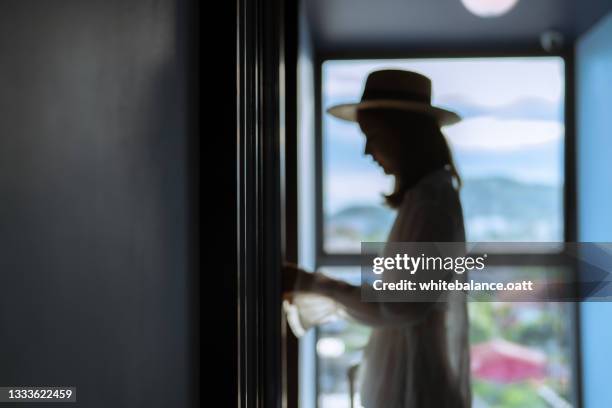 woman tourist in casual clothes is walking to her room. - entering imagens e fotografias de stock