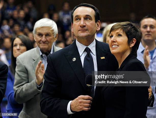 Duke head coach Mike Krzyzewski and his wife, Mickie, watch as a new banner celebrating his NCAA Division I record is unveiled after the Davidson...