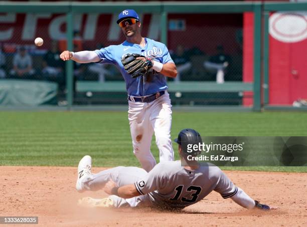 Whit Merrifield of the Kansas City Royals throws past Joey Gallo of the New York Yankees to first to complete a double play in the third inning at...