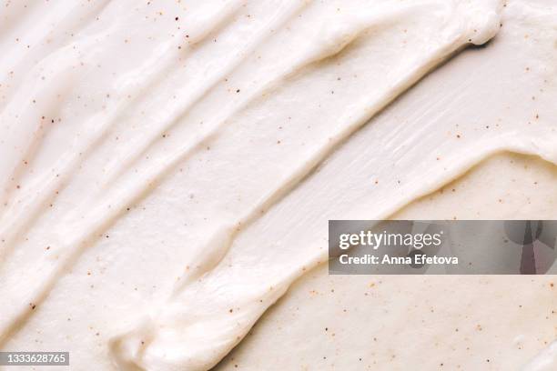 texture of beige body scrub with exfoliating particles. flat lay style - vanilleeis stock-fotos und bilder