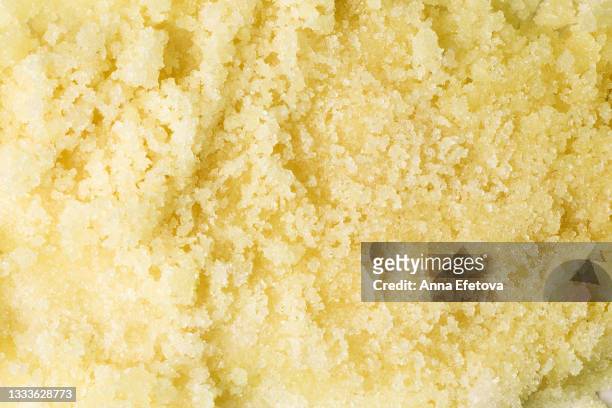 texture of pastel yellow sugar scrub. concept of body care. trendy color of the year. flat lay style - scrub texture photos et images de collection