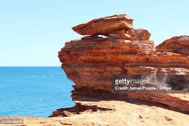 view of rock formation in sea against clear sky,minyirr,western australia,australia - james popple stock pictures, royalty-free photos & images