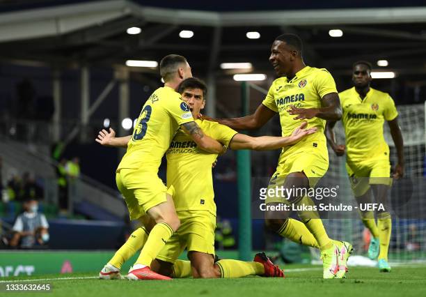 Gerard Moreno of Villarreal celebrates with teammates Moi Gomez and Pervis Estupinan after scoring their team's first goal during the UEFA Super Cup...