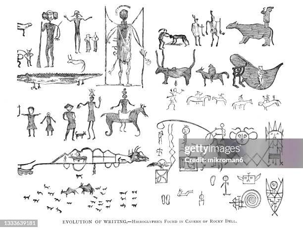 old engraved illustration of evolution of writing - hieroglyphics found in cavern of rocky dell - hieroglyphics stock-fotos und bilder