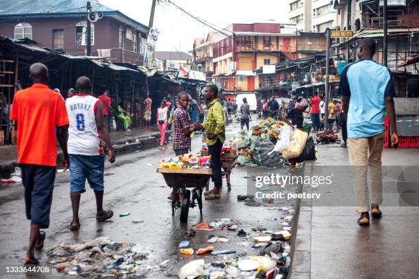 rainy day in african city - lagos, nigeria - nigeria man stock pictures, royalty-free photos & images