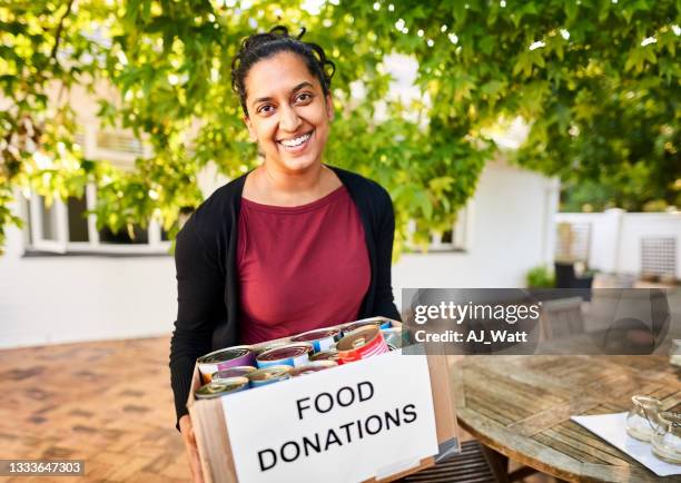 woman with food donation box at a community center - donation box stock pictures, royalty-free photos & images