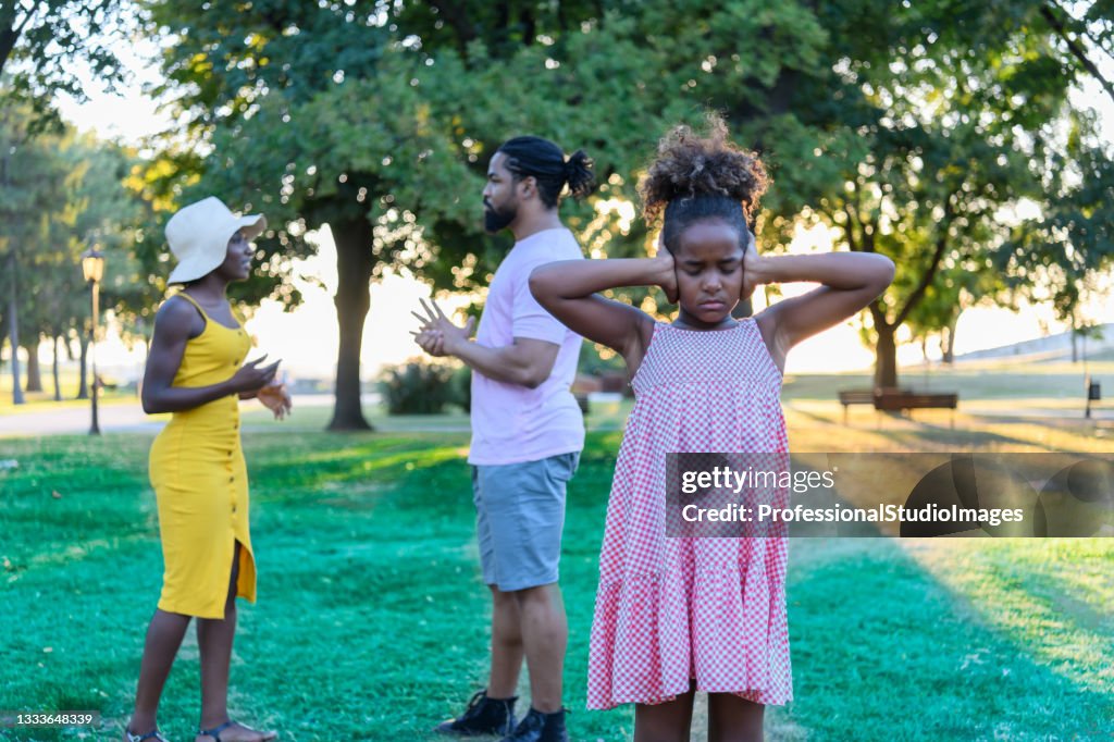 African-American Family is Solving Family Problems Outside in Nature During a Springtime.