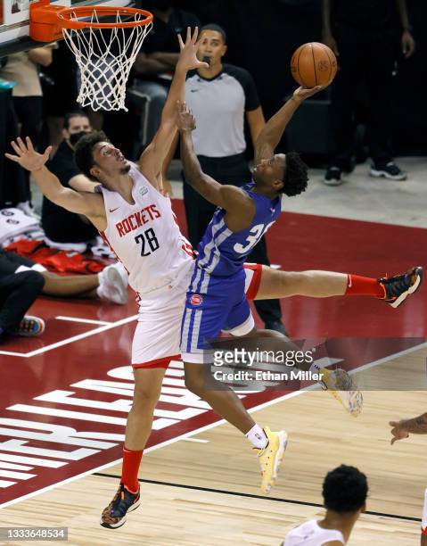 Alperen Sengun of the Houston Rockets takes a charge from Saben Lee of the Detroit Pistons during the 2021 NBA Summer League at the Thomas & Mack...