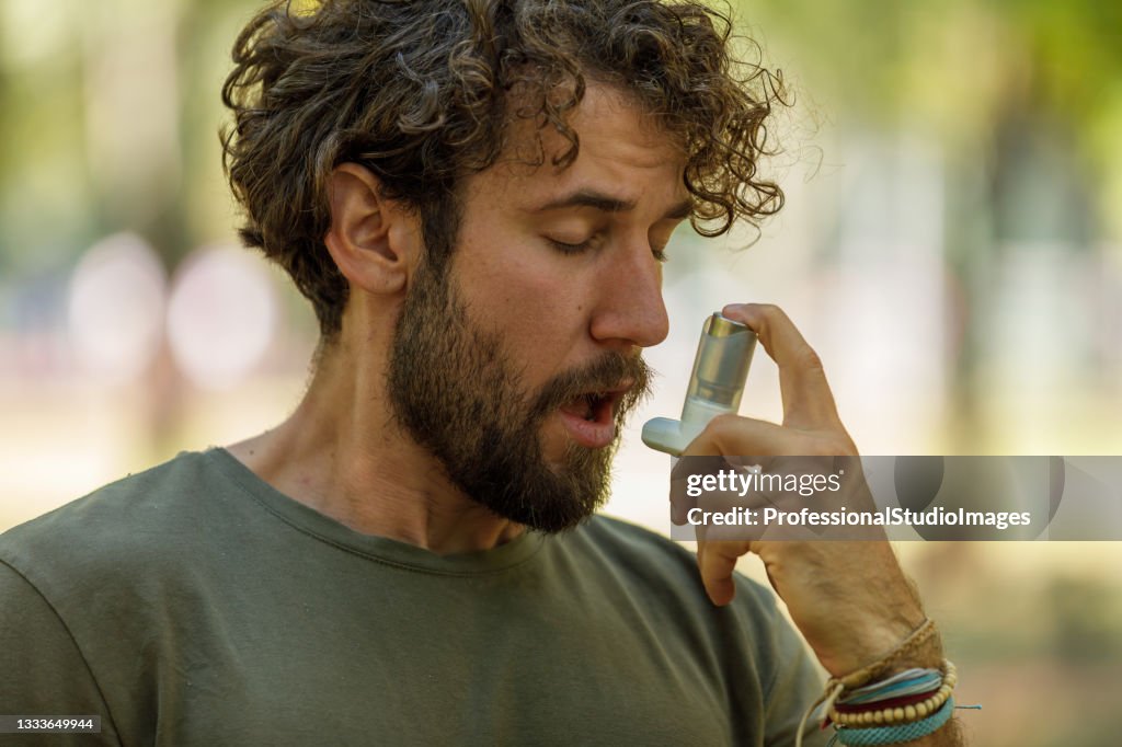 Handsome Man has Problems with the Respiratory System so He Uses an Inhaler.