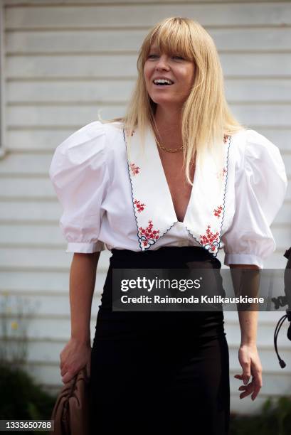 Jeanet Madsen wearing black skirt and white shirt with wide collar outside Helmstedt during Copenhagen fashion week SS22 on August 11, 2021 in...