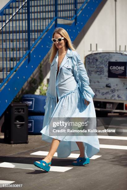 Guest wearing blue long dress outside Designer Remix during Copenhagen fashion week SS22 on August 11, 2021 in Copenhagen, Denmark.