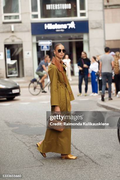 Hilda Sandstrom wearing long coat outside By Malene Birger during Copenhagen fashion week SS22 on August 11, 2021 in Copenhagen, Denmark.