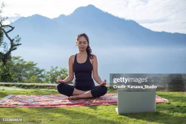 indonesian woman meditating in nature - professor de ioga imagens e fotografias de stock