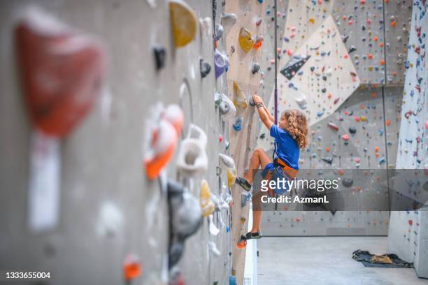 young man and woman preparing climbing ropes for workout - kids climbing stock pictures, royalty-free photos & images
