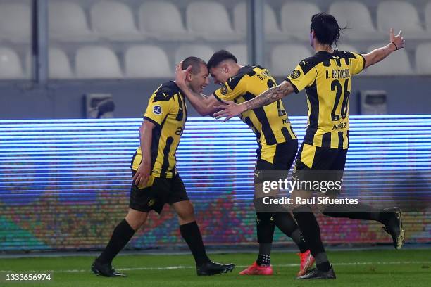Walter Gargano of Peñarol celebrates with teammates after scoring the third goal of his team during a quarter final first leg match between Sporting...