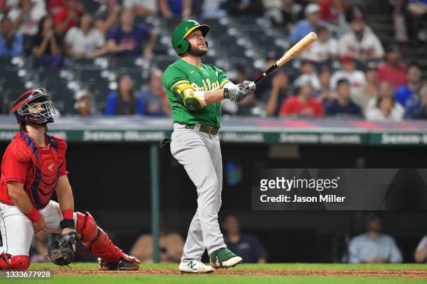 Jed Lowrie of the Oakland Athletics watches a three run homer clear the right field fence during the eighth inning against the Cleveland Indians at...