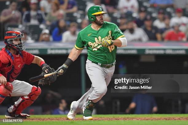 Mitch Moreland of the Oakland Athletics hits a sacrifice RBI ground ball during the seventh inning against the Cleveland Indians at Progressive Field...