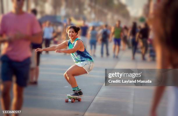 woman skateboarding - venice beach boardwalk - afro caribbean and american stock pictures, royalty-free photos & images