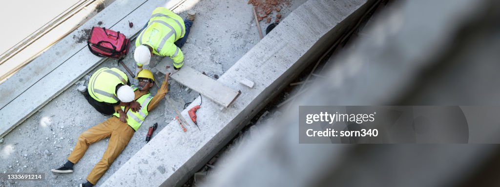 First aid, Start Compressions using both hands, Life-saving and rescue methods after unconscious. Accident at work in construction job of worker near construct building. Banner with copy space
