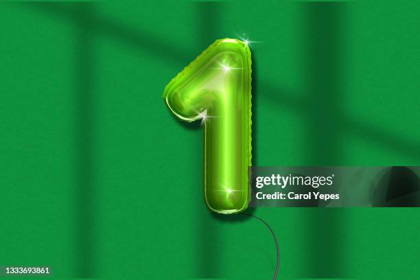 number one foiled balloon in green colors. - first light awards inside stock pictures, royalty-free photos & images