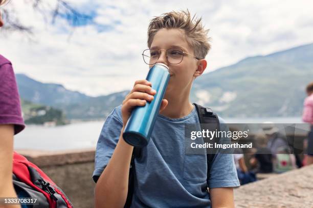 little boy hiker drinking from reusable water bottle. - reusable stock pictures, royalty-free photos & images