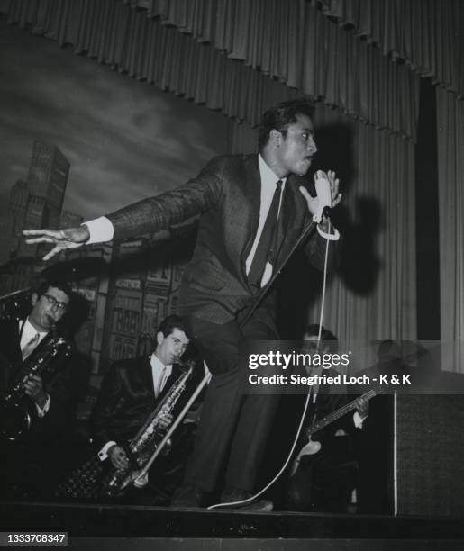 Little Richard performs on stage at the Star Club, Hamburg, Germany, 1962. Keyboard player Billy Preston is back right.