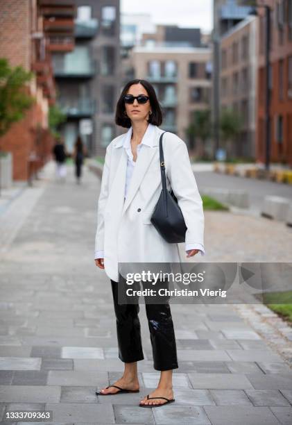 Ilenia Toma seen wearing white blazer, latex pants outside Designers Remix on August 11, 2021 in Copenhagen, Denmark.