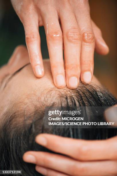 ayurvedic oil treatment for healthy hair - house warm heating oil stockfoto's en -beelden