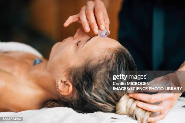 ayurvedic practitioner using crystals for chakra healing - chakras stock pictures, royalty-free photos & images