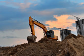 Excavator digging foundation at construction site. Heavy machinery for groungwork. House Construction Project Working.