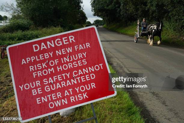 Horse and trap is driven along the Flashing Lane on the first day of Appleby Horse Fair on August 12, 2021 in Appleby, England. The fair is an annual...