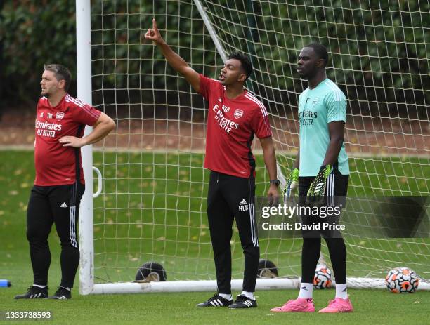 Kevin Betsy Arsenal U23 Head Coach with Ovie Ejeheri during the Arsenal U23 training session at London Colney on August 12, 2021 in St Albans,...