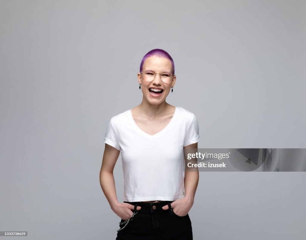 Cheerful young woman with short purple hair