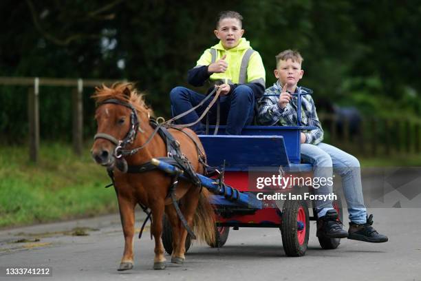 Horses and traps are driven along the Flashing Lane on the first day of Appleby Horse Fair on August 12, 2021 in Appleby, England. The fair is an...