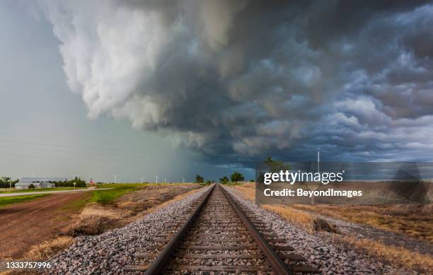 severe storm with torrential rain over railroad tracks and farm land - hot weather bildbanksfoton och bilder