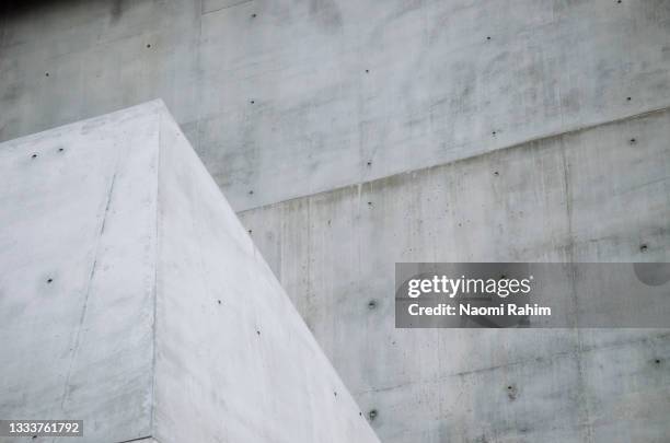 angled white concrete block contrasting with gray off-form concrete wall - brutalism stock pictures, royalty-free photos & images