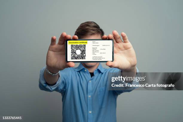 man using digital vaccine passport app in mobile phone - covid 19 vaccine card stock pictures, royalty-free photos & images