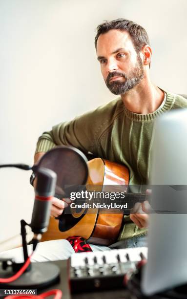 musician playing guitar during online concert - epidemic sound stock pictures, royalty-free photos & images