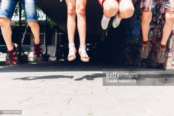 happy kids jumping - summer school stockfoto's en -beelden