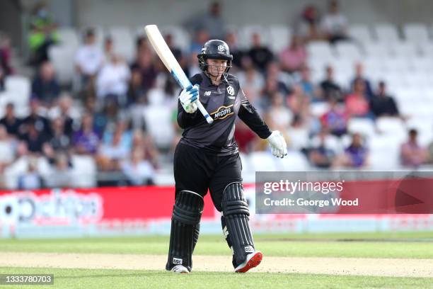 Lizelle Lee of Manchester Originals raises their bat after reaching 50 runs during The Hundred match between Northern Superchargers Women and...