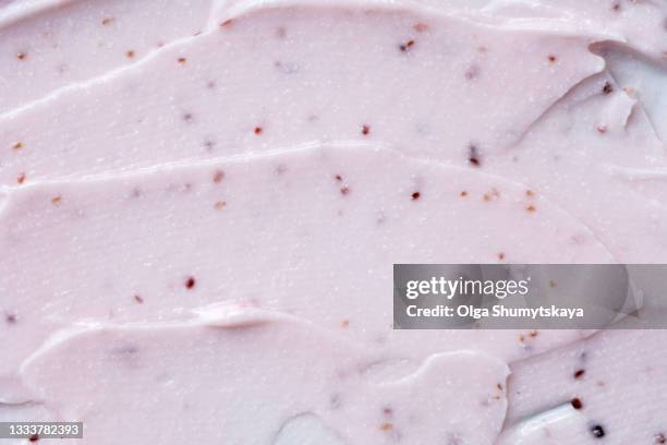 a smear of pink raspberry scrub with a creamy texture - body scrub stock-fotos und bilder