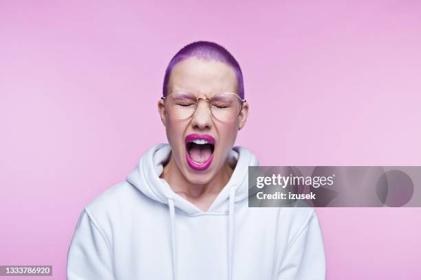 angry young woman with short purple hair - purple hair stock pictures, royalty-free photos & images