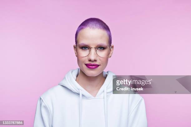 freundliche junge frau mit kurzen lila haaren - purple hair stock-fotos und bilder