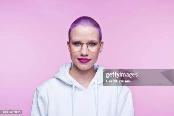 friendly young woman with short purple hair - completely bald woman stock pictures, royalty-free photos & images