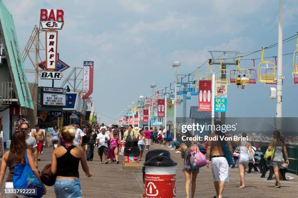 people walk on boardwalk of seaside heights, nj. - seaside heights fotografías e imágenes de stock